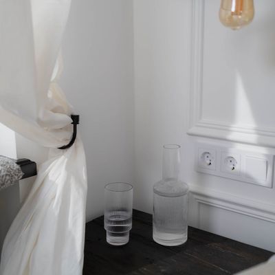 A yoga mat and a water bottle in a quiet, serene space.